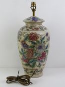 A ceramic table lamp in the style of a Chinese ginger jar having Iris and other floral design upon,