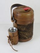 A South African flask, leather and hide covered, with accessories.