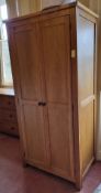 A pair of contemporary oak wardrobes, eaach 90 x 57 x 184cm.