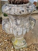 A pair of pre-cast stone urns, each standing 70cm high.
