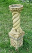 A contemporary pre-cast stone birdbath standing 3ft high.