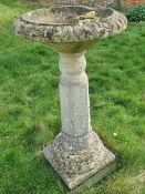 A pre-cast stone pedestal birdbath having hexagonal column, a/f, 106cm hgih.