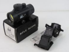 A Trigon Red Dot Scope with manual in bo