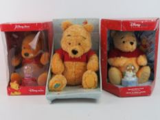 Three Disney Winnie the Pooh plush toys,