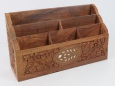 A carved wooden letter rack, probably In