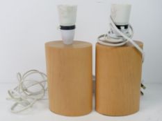 A pair of contemporary wooden table lamp
