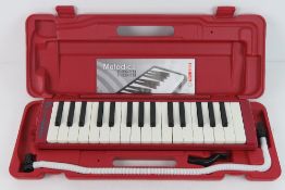 A Horner Melodica Student 32 in red, as