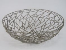 A handcrafted metal fruit bowl.