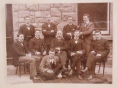 A black and white photograph of suited m