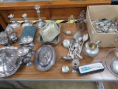 A large quantity of silver plated items including pair of candlesticks, tureens, toast rack,