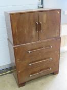 Mid century cabinet having twin doors over three graduated drawers, British made label to back, 83.