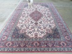 A 100% wool rug in red, cream and navy ground having floral pattern, approx 344 x 248cm.