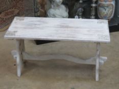 A white painted garden bench, 75cm wide.