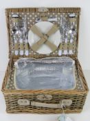 An as new wicker picnic hamper for two including thermal lining, cutlery, plates, bottle opener,
