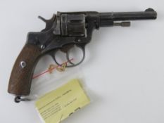 A deactivated Belgian Nagant 7.62mm Revolver with wooden grips.