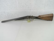 A deactivated English Double Barrel 12 Gauge Coach Hammer Shotgun by Adams and Co.