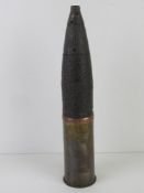 An inert WWII Russian Regimental gun shell dated 1944 on the base of the case with original