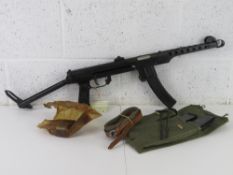 A deactivated PPS-43 SMG with three spare magazines, mag pouch, Cleaning rod, and Oil bottle.