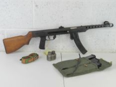 A deactivated PPS-52 SMG with three spare magazines, mag pouch, Cleaning rod, and Oil bottle.