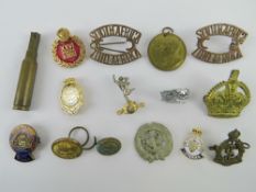 A quantity of assorted military themed and cap badges including South Africa items.