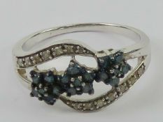 A contemporary silver cz set floral ring, stamped 925, size P-Q.
