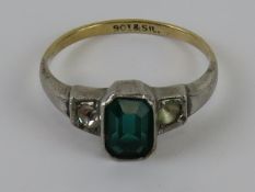 An Art Deco 9ct gold and silver ring having octagonal faceted central green stone,