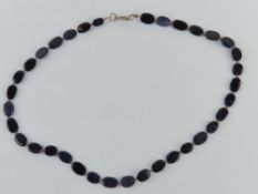 A blue gold stone beaded necklace with silver clasp stamped 925 approx 42cm in length.