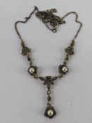 A silver marcasite and pearl articulated necklace, stamped 925 throughout,
