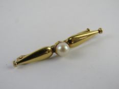A yellow metal bar brooch having partial hallmark to pin, French style clasp with central pearl, 1.