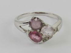 A silver ring set with pink, purple and white stones, stamped 925, size Q.