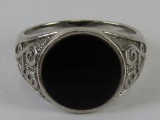 A men's silver and onyx signet ring, stamped 925, size V, having Celtic style pattern upon.