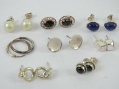 A quantity of assorted pairs of silver earrings including onyx, lapis lazuli, smoky quartz, etc.