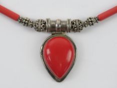 A silver and faux coral necklace having teardrop shaped pendant upon, stamped 925.