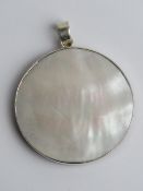 A double sided silver pendant, red hardstone and mother of pearl, 4cm wide.