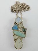 A silver and assorted agate pendant, stamped 925, 3.8cm in length, on silver chain.