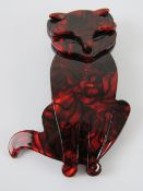 An overlaid plastic brooch in the style of Lea Stein in the form of a red cat, 7.5cm high.