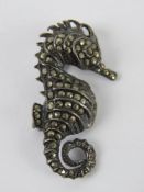 A silver and marchasite brooch in the form of a seahorse, stamped 925, 3.5cm high.
