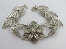 A silver filigree bracelet of floral design, slight adjustable length, 17.5 - 18cm, stamped I.R 925.