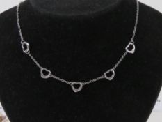 A silver five heart necklace, stamped 925, adjustable length 43 - 45cm.