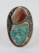 A large and impressive silver Boho native American style turquoise and red stone ring,