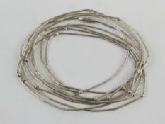 An unusually long Native American style silver beaded necklace, no apparent hallmarks,