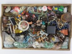 A wooden tray containing a large quantity of assorted costume jewellery including hardstone