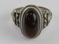 An garnet cabachon men's ring having deep red hue, white metal no apparent hallmark, size U.
