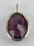 A faceted purple stone pendant, no apparent hallmarks, 2.3cm in length.