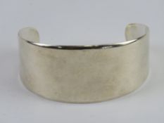 A hallmarked silver graduated open bangle (3.2cm at widest) London hallmark.