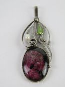 A handmade filigree floral pendant having large purple stone, 5.5cm inc bale.