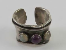 A hallmarked silver handmade Arts and Crafts style ring set with amethyst and moonstone cabachons,