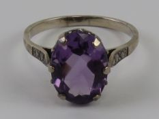 A vintage silver and amethyst cocktail ring, the oval cut stone approx 13 x 10mm, stamped SIL,