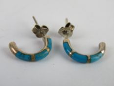 A pair of silver and turquoise half hoop earrings stamped 925 to the butterfly backs.