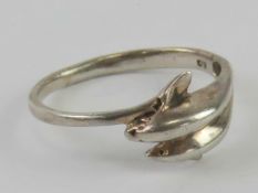 A silver ring in the form of two leaping dolphins, stamped 925, size T.